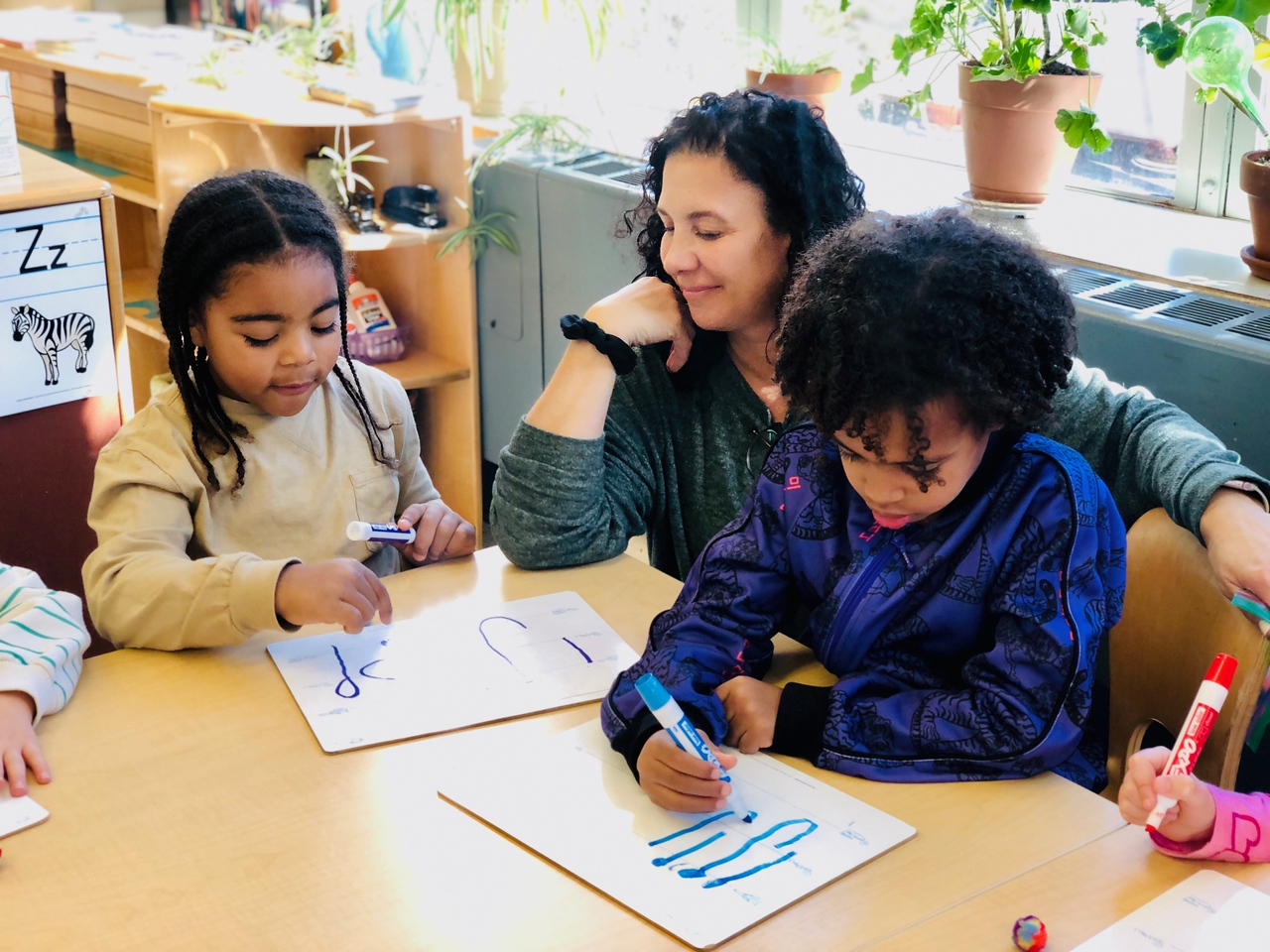 Fieldston Lower students practice writing letters with their language specialist.