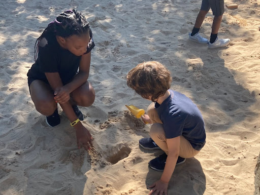 Fieldston Lower buddies play together in the sand.