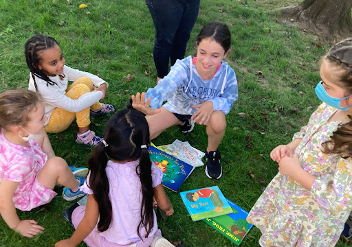 Students at Fieldston Lower gather in a group to read together. 