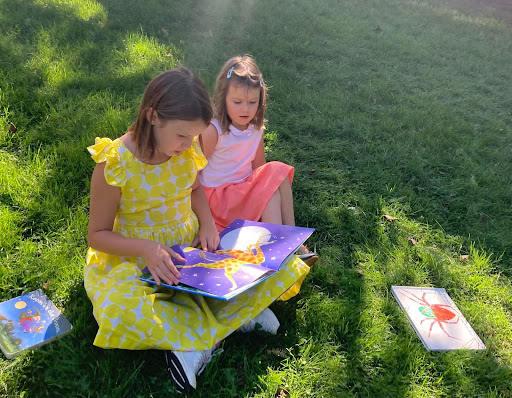 Students at Fieldston Lower gather in a group to read together. 