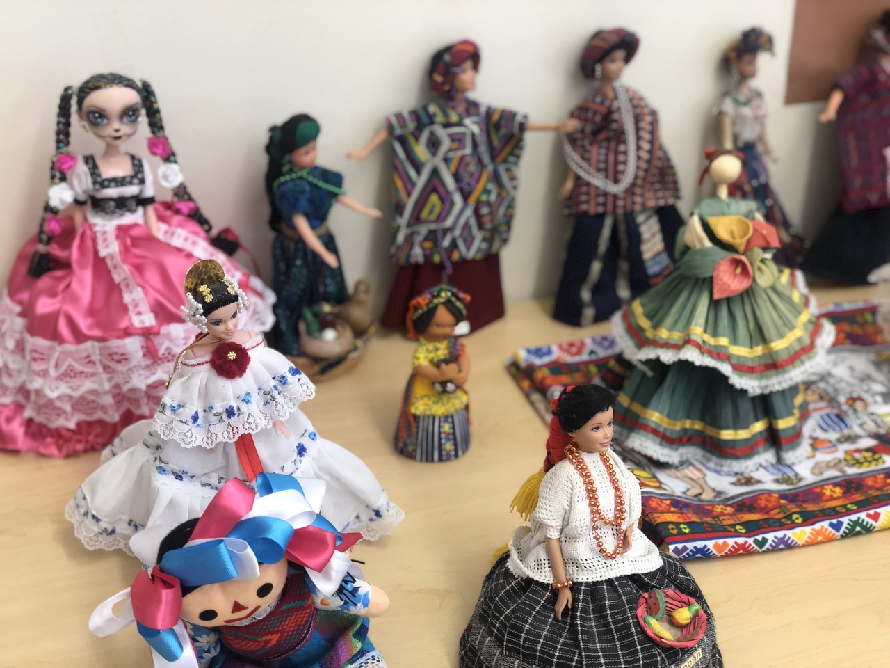 Dolls wearing traditional dress sit on table in Fieldston Upper classroom