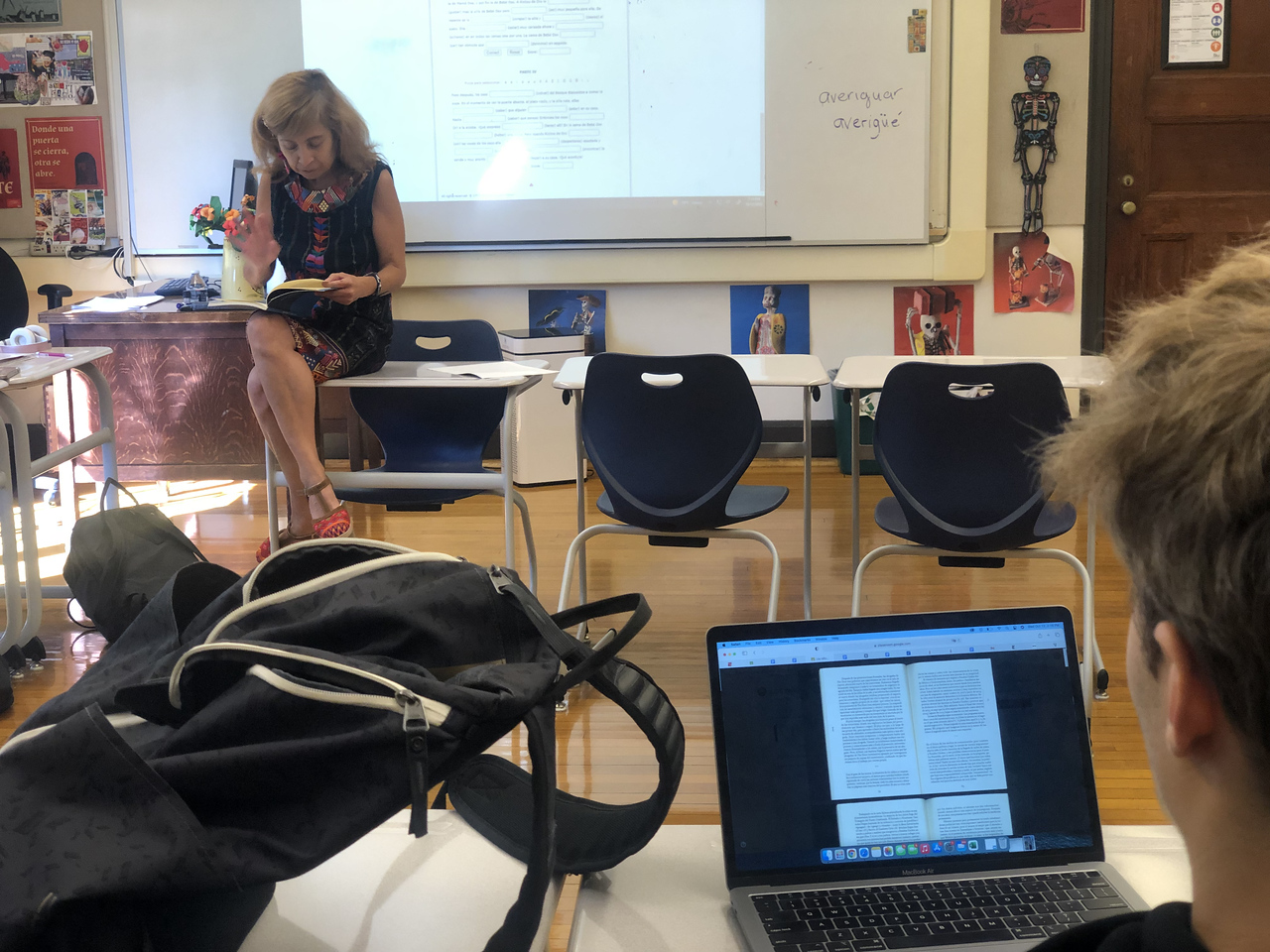 Student looks on during discussion in Fieldston Upper Spanish class. His computer is out on his desk.