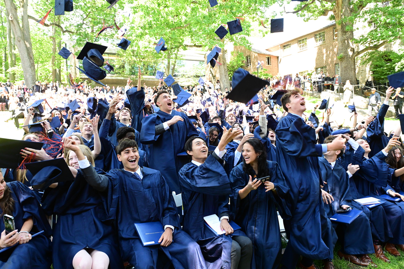 Fieldston Upper students throw their caps in the air at Commencement.