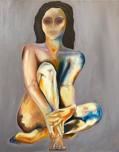 Photo of Fieldston Upper student painting portrait of a women sitting cross-legged. 