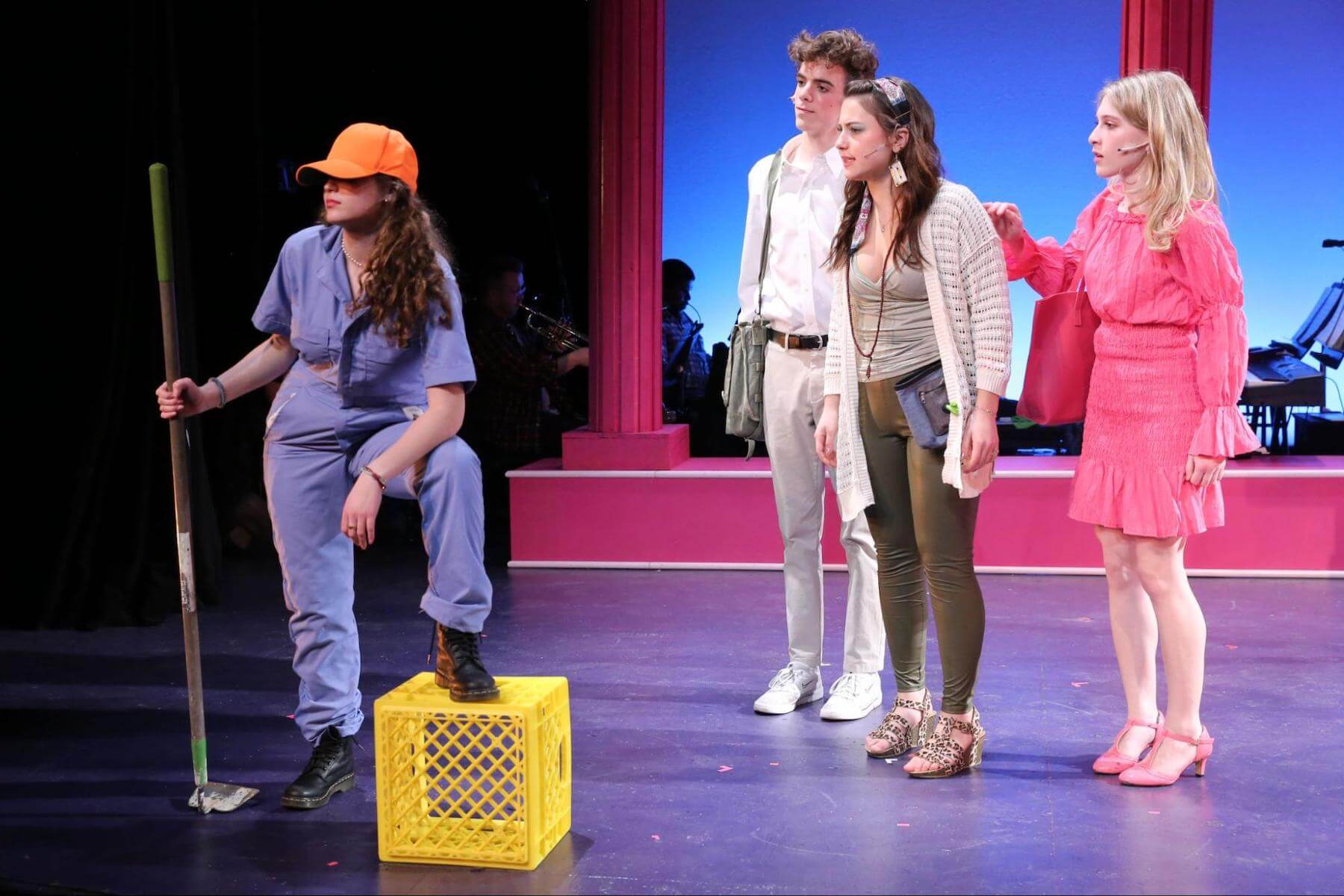 Four Ethical Culture Fieldston Upper School students perform onstage together in Legally Blonde.