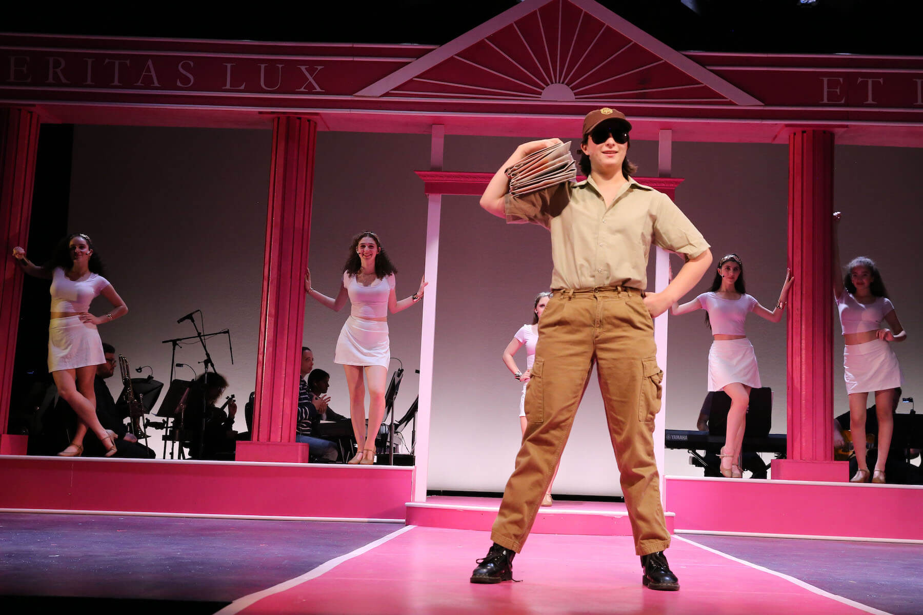 An Ethical Culture Fieldston Upper School student poses onstage in Legally Blonde.
