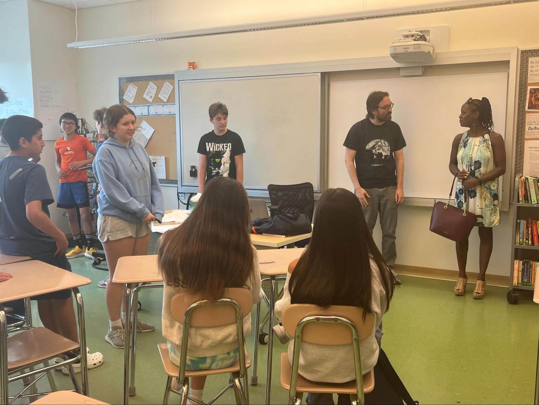 Ethical Culture Fieldston School 8th Graders visit with a guest for their capstone outside.