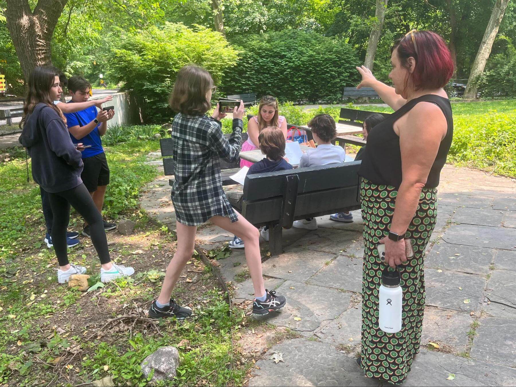 Ethical Culture Fieldston School 8th Graders interview a guest for their capstone outside.