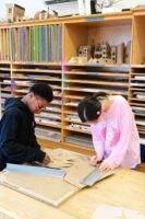 A Fieldston Middle student works on a model building project.