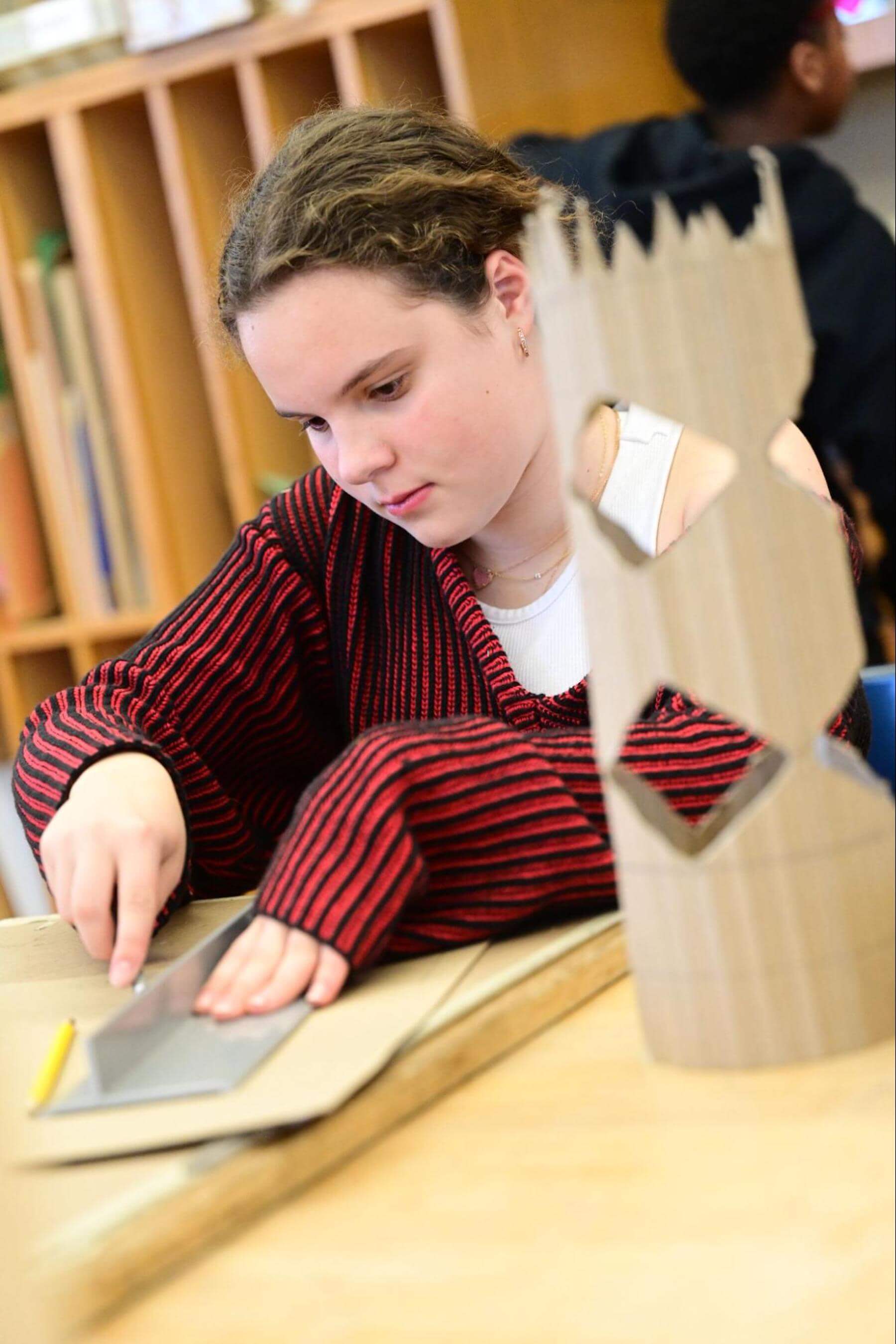 A Fieldston Middle student works on a model building project.