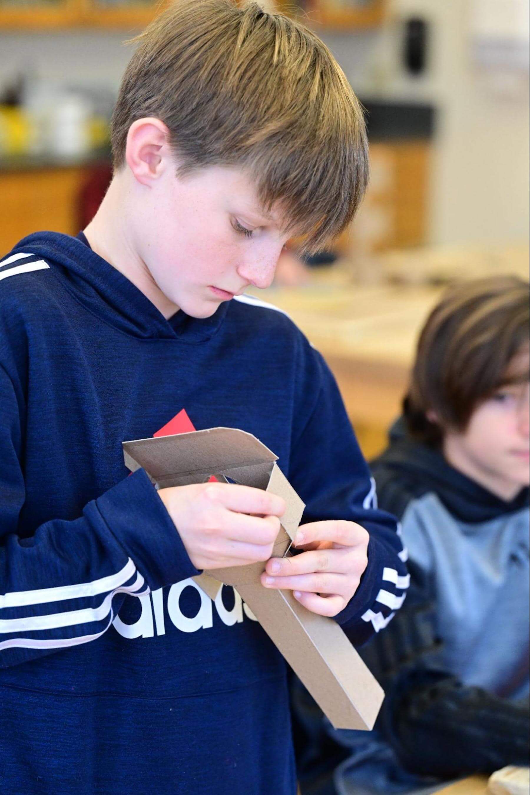 A Fieldston Middle student works on a project in model building class.