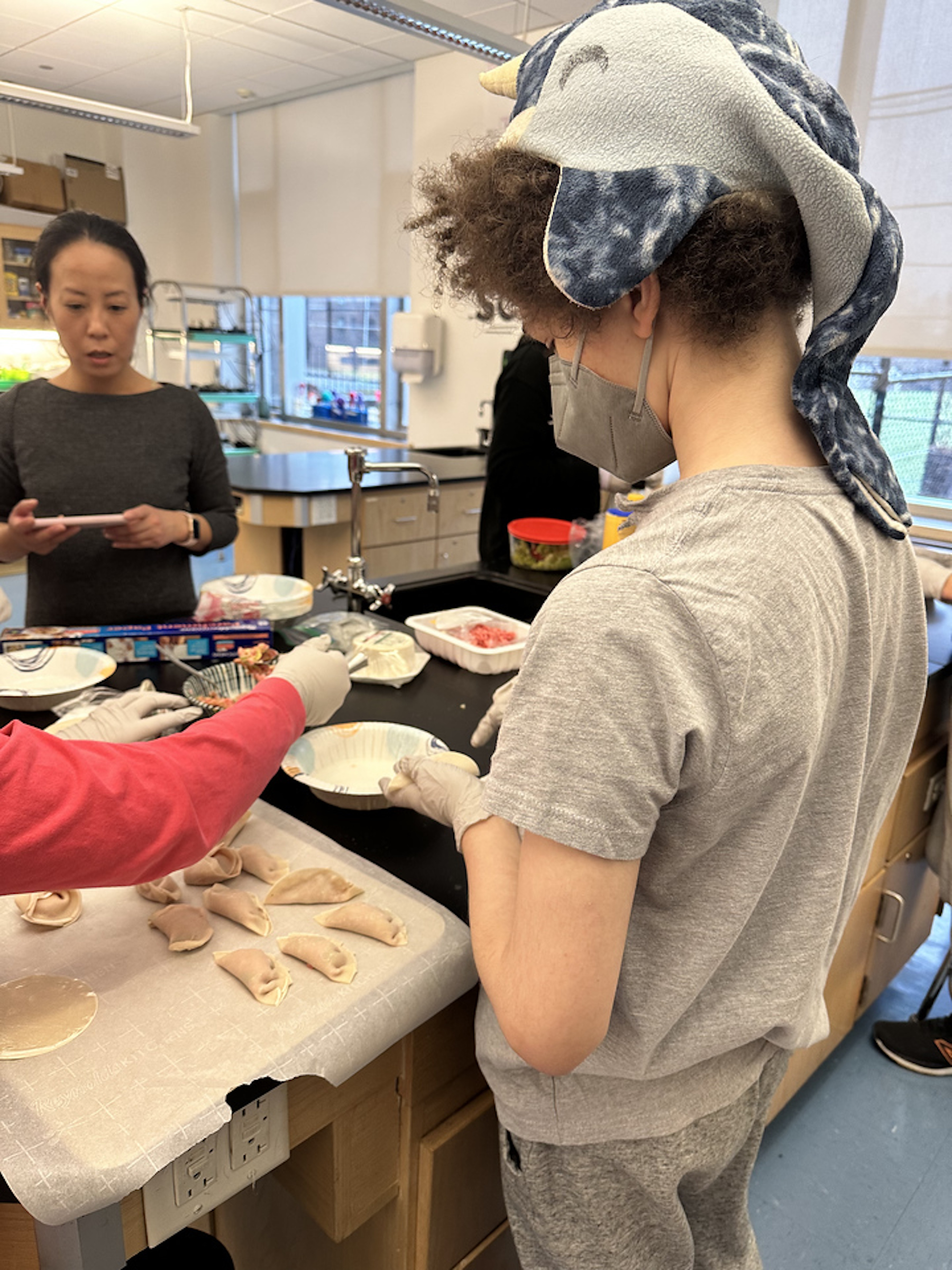 Fieldston Middle student wraps dumpling.