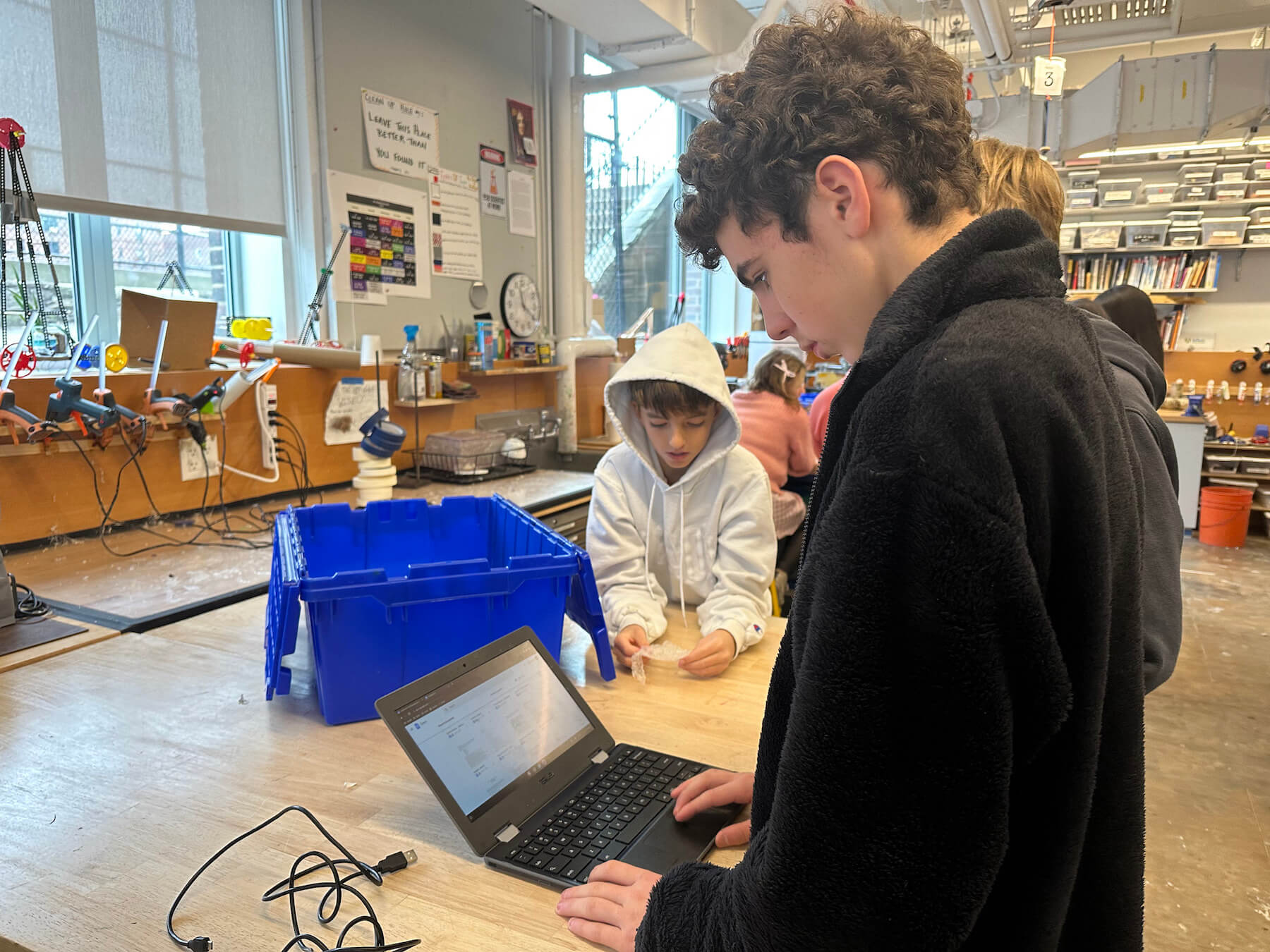 Three Ethical Culture Fieldston School students work on a project.