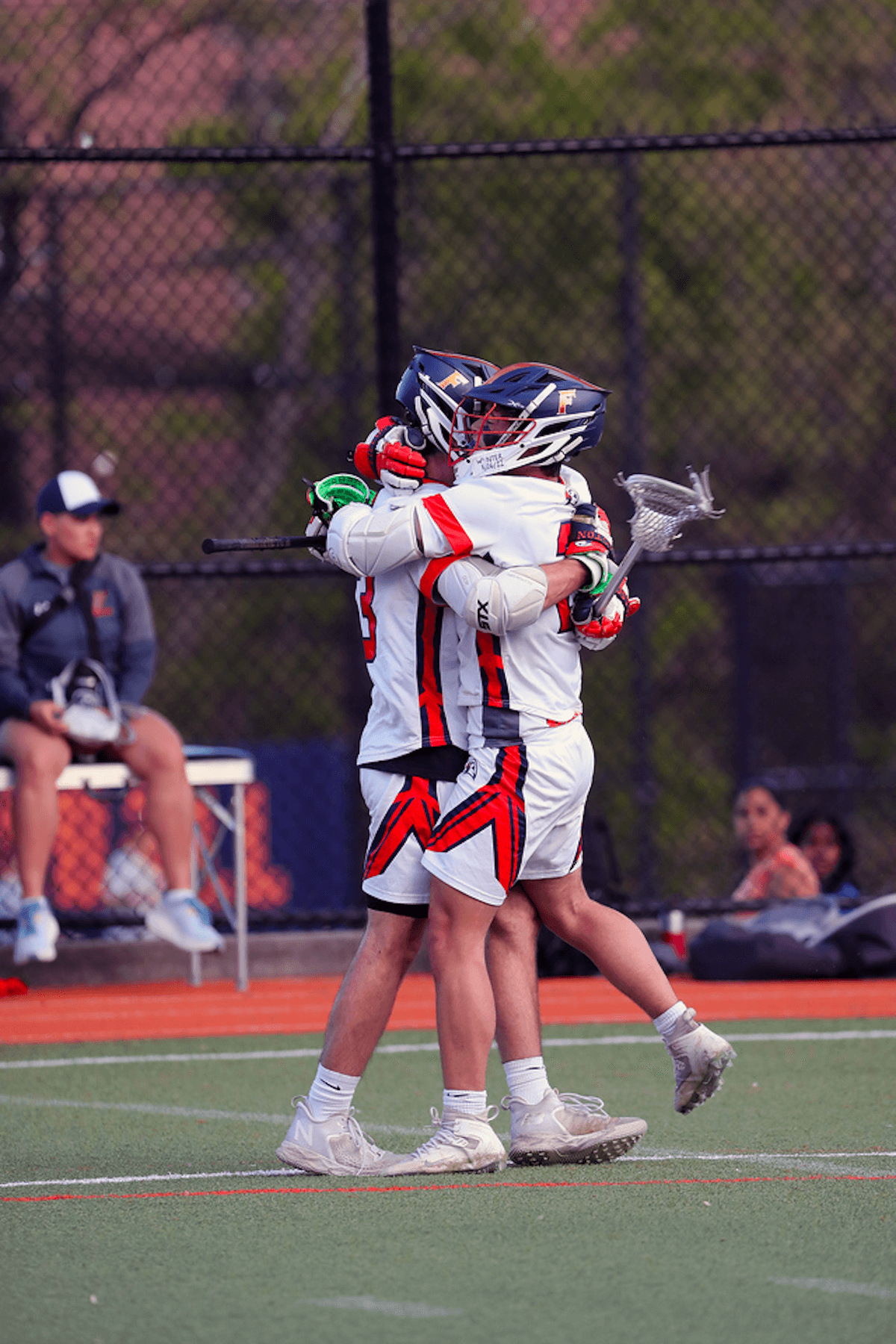 Two Ethical Culture Fieldston lacrosse players hug it out at Spring Fling.