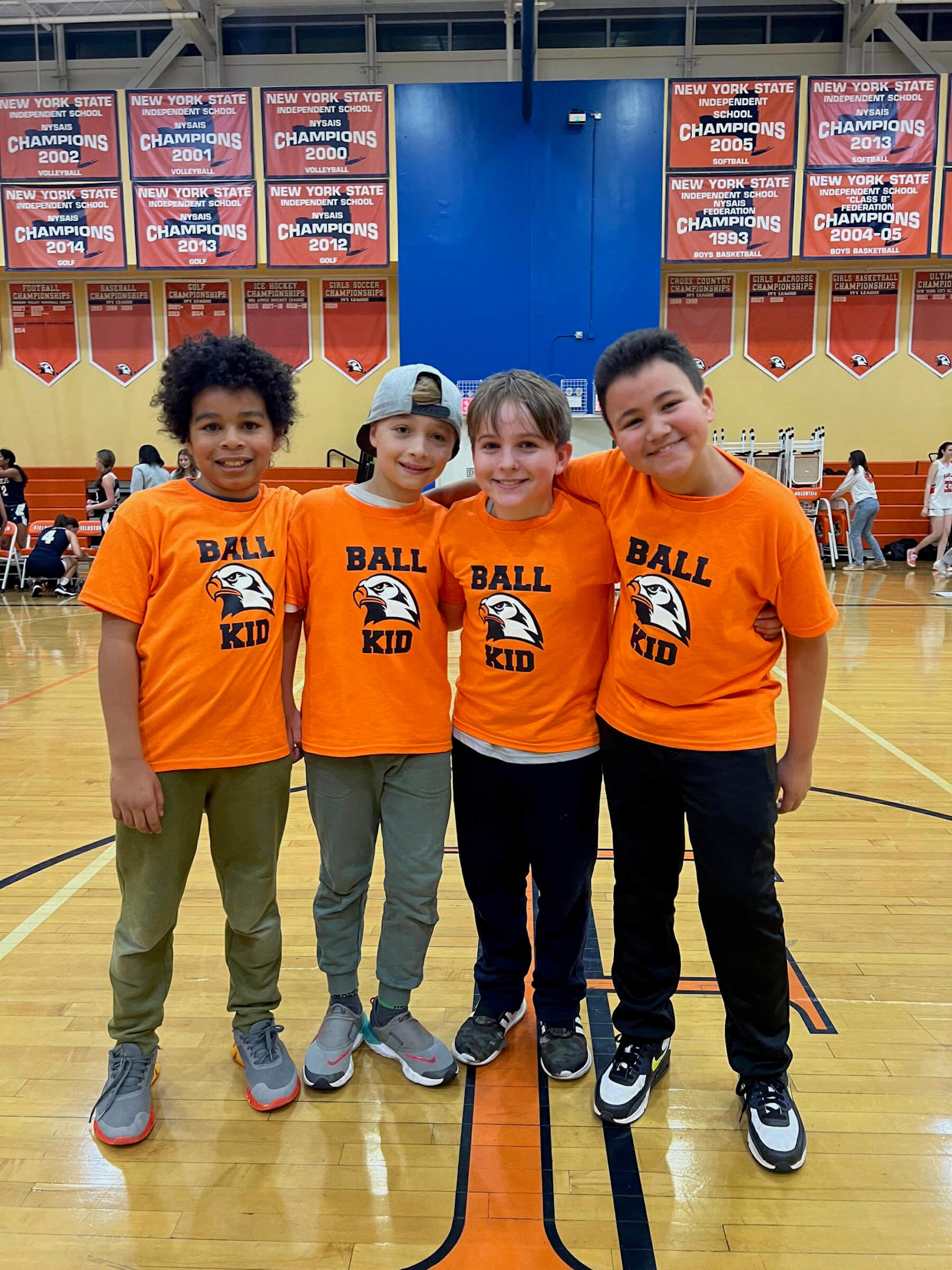 Four Ethical Culture FIeldston School Fieldston Lower Students for basketball ball kids smiling at camera
