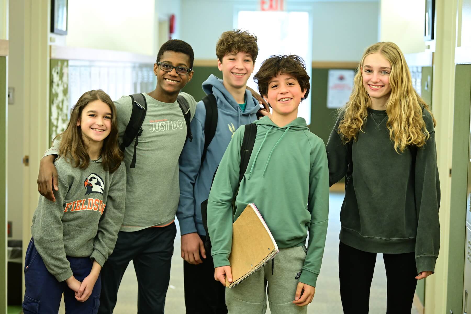 Ethical Culture Fieldston School Fieldston Fieldston Middle students stand together in hall smiling