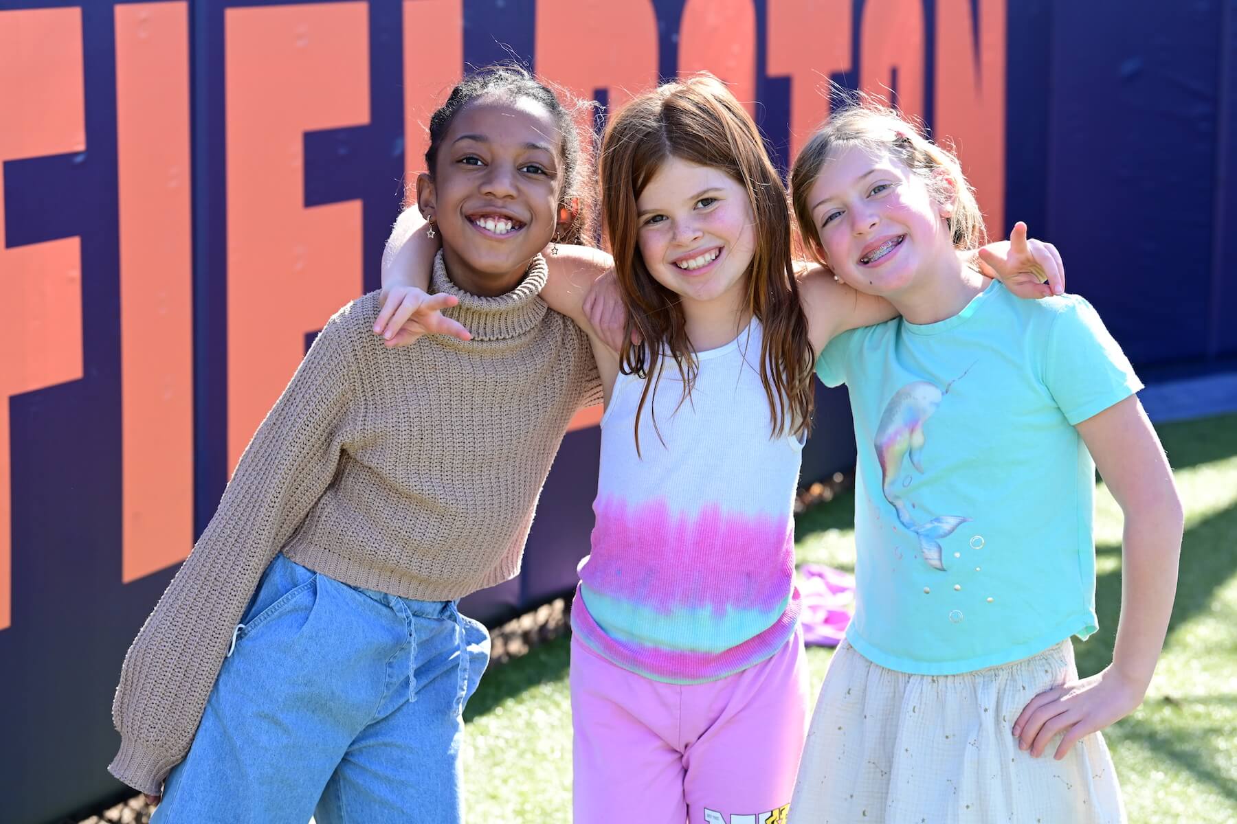 Three Ethical Culture FIeldston School Fieldston Lower Students smiling with arms around each other