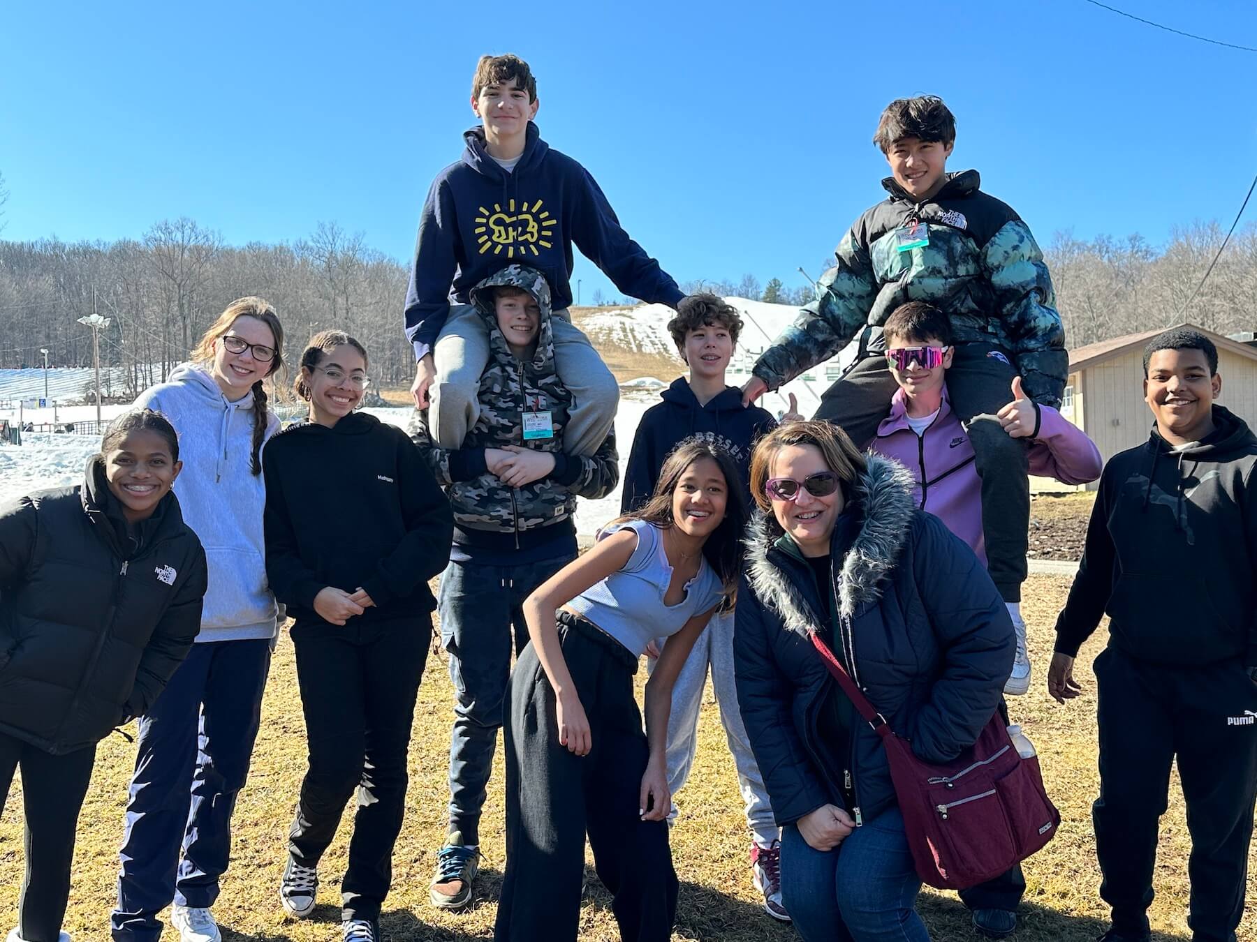 Group of Ethical Culture FIeldston School Fieldston Middle Students smiling at camera after enjoying a day of snow tubing