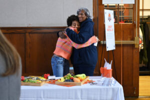 Ethical Culture Fieldston School Fieldston Upper student hugs a long time Fieldston alumni Janet