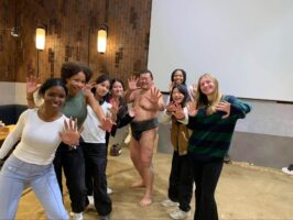 A group of Ethical Culture Fieldston Upper School students pose with a sumo wrestler in Japan