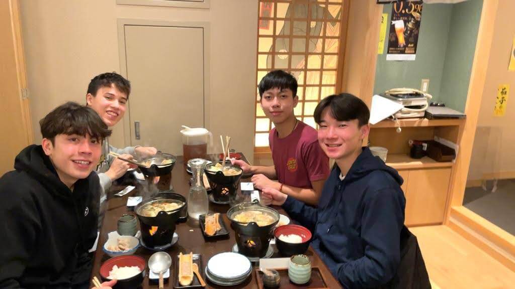 Four Ethical Culture Fieldston Upper School students enjoy dinner together in Japan