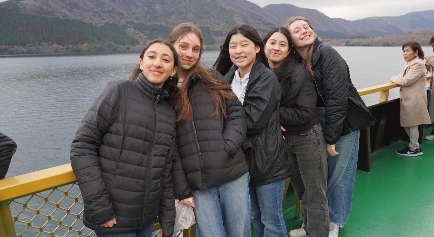 Five Ethical Culture Fieldston Upper School students stand on a boat in Japan