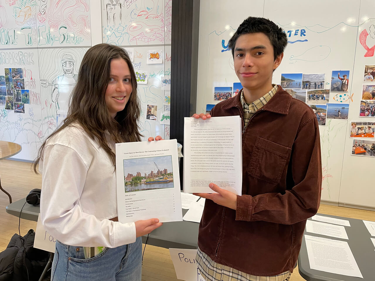 Two CitySem students pose with copies of their written essays.