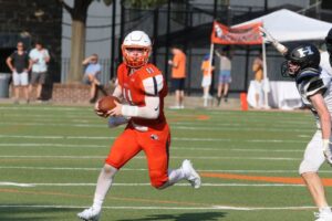 Football player runs with the ball during game