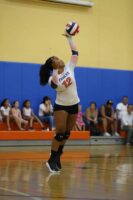 Student serves during volleyball match