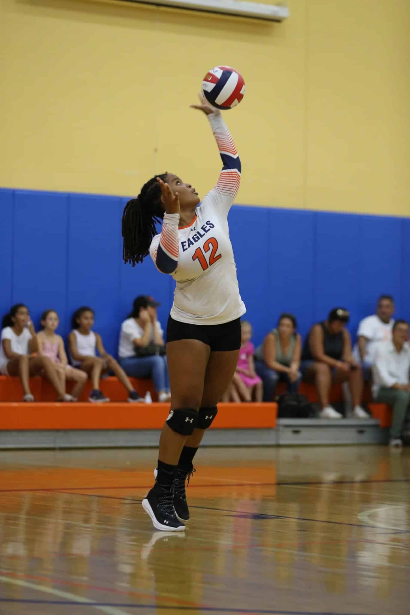 Student serves during volleyball match