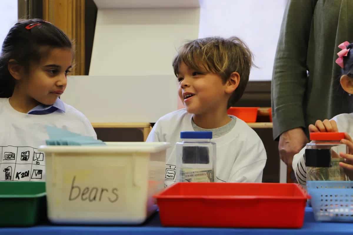 Student smiles while organizing money