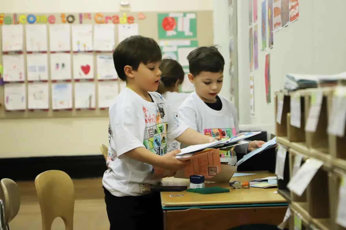 Students organize mail into bins