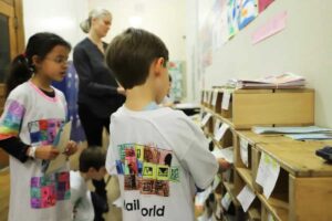 Students place mail in mailboxes