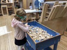 Student looks through blocks in Woodshop