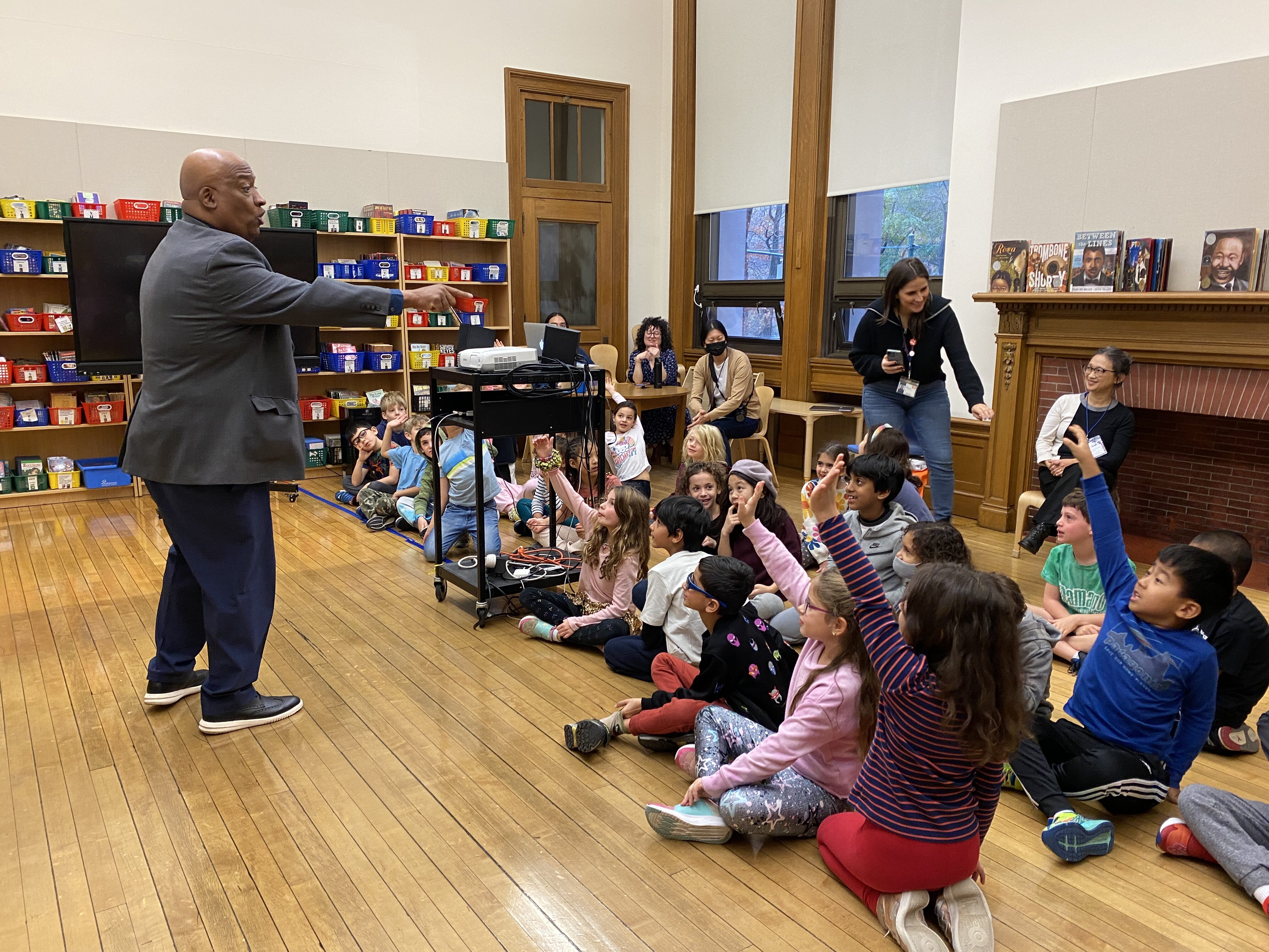 Bryan Collier pointing at a student who is raising his hand