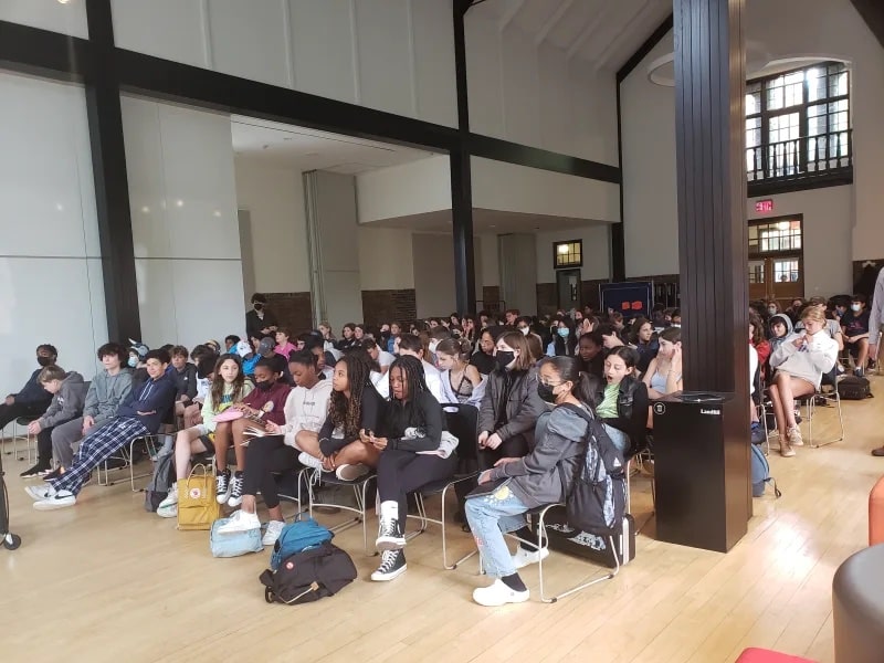 Large group of students listen to talk in the Student Commons