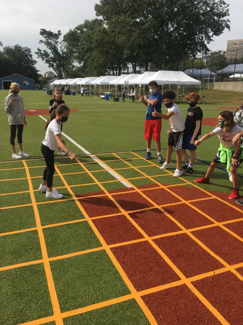 Students play game together outdoors