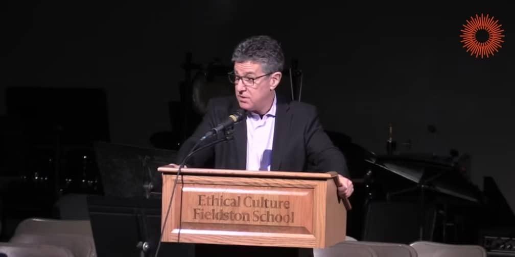 Rabbi gives speech from podium in auditorium