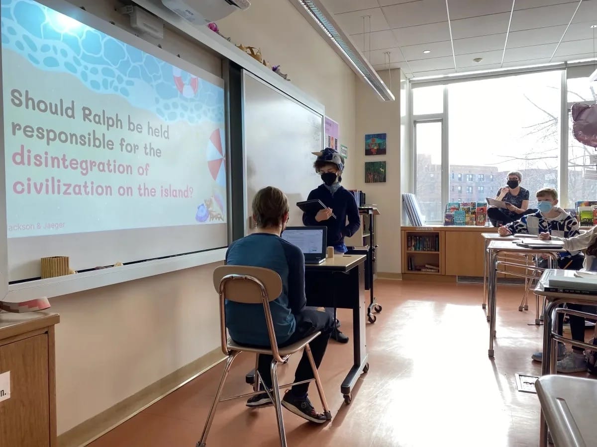 Students discuss book in classroom