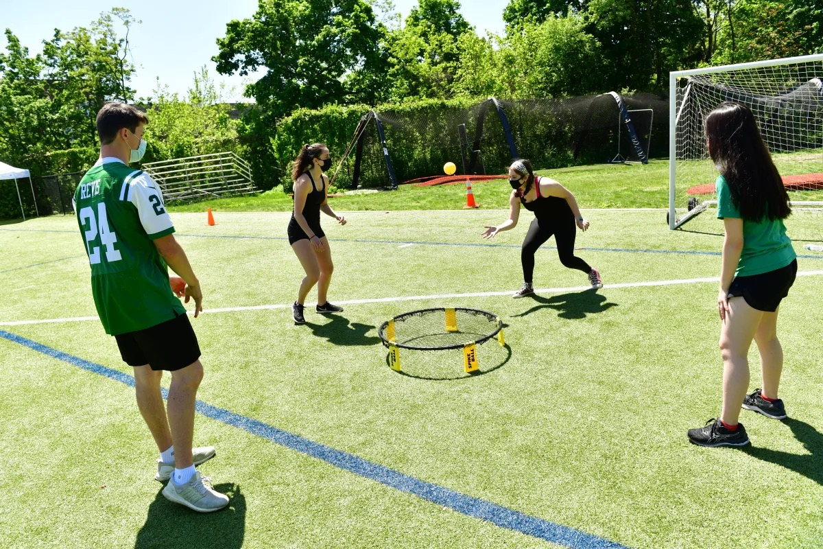 Students play game outside on Upper Field