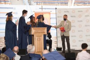 Students hand flowers to Carl Anhalt as tribute