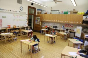 Students sit physically distanced at their desks in classroom