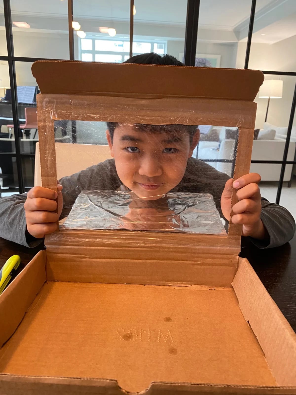 Student poses with solar oven