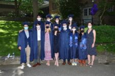 Group of students pose together on Quad