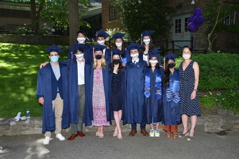 Group of students pose together on Quad