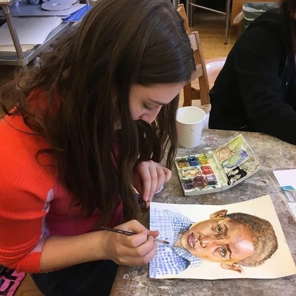 Student works on her portrait