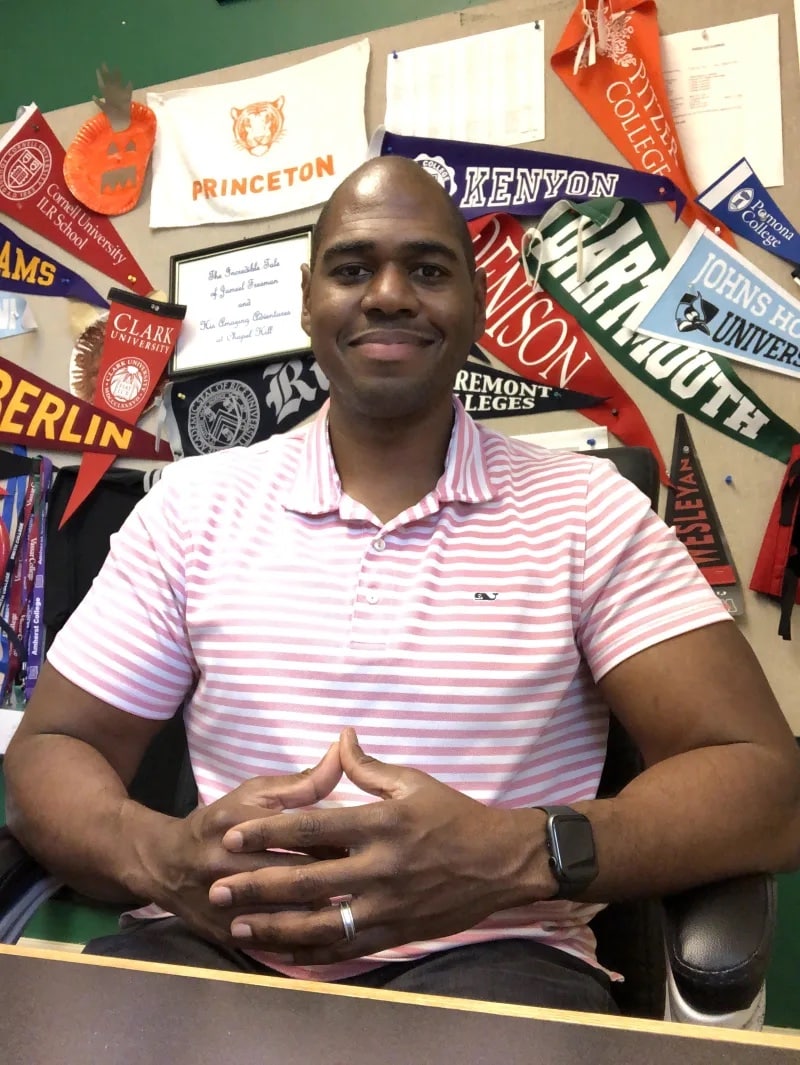 Jameel Freeman smiles at his desk