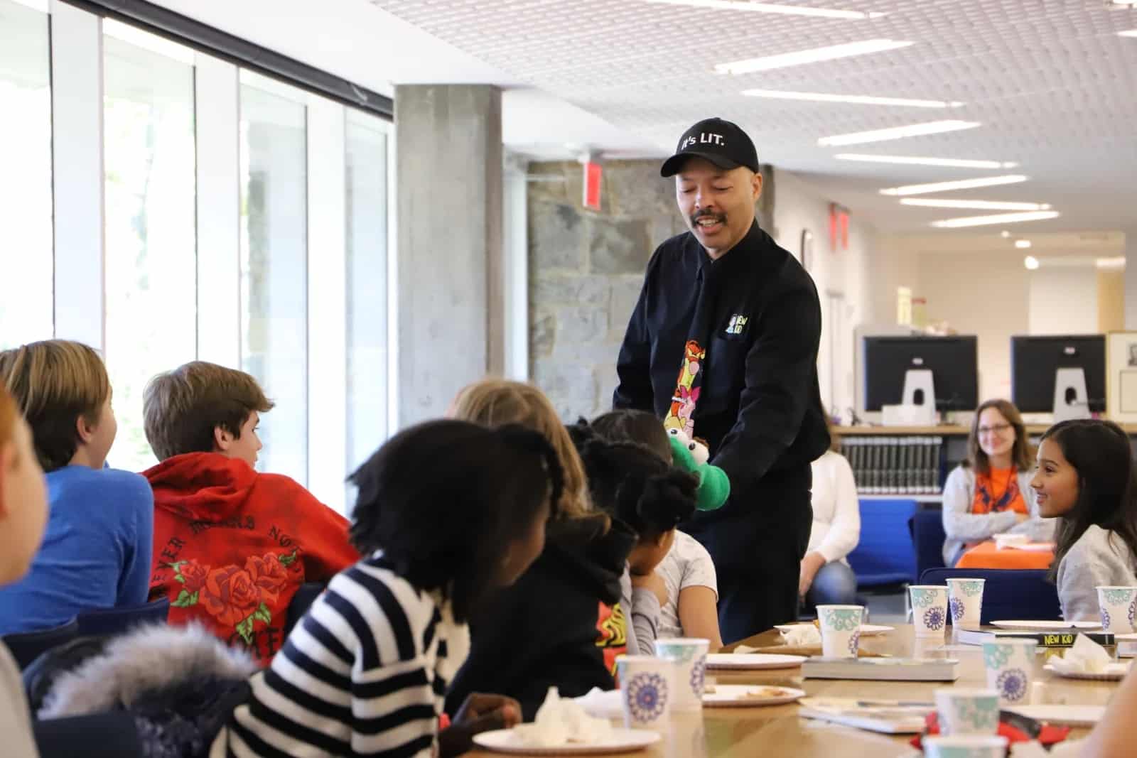 Craft interacts with students using sock puppet