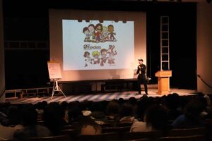 Craft gives presentation to students in auditorium