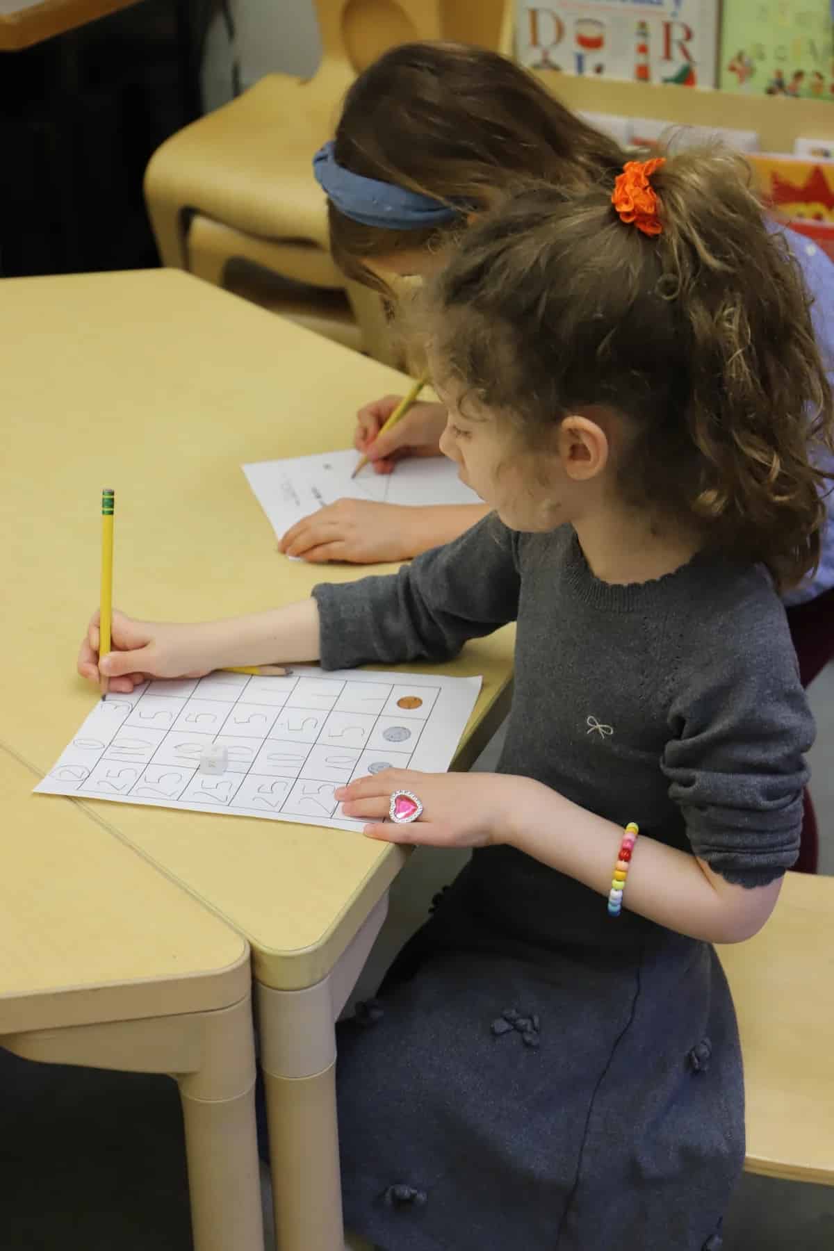 Student uses chart to count money